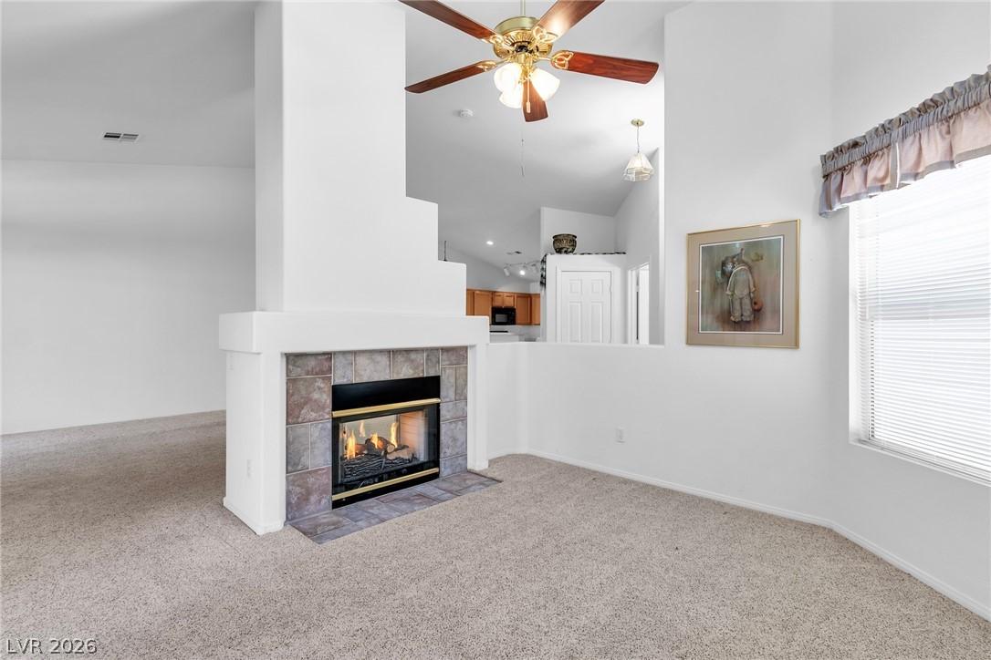 Image 4: Unfurnished living room with a ceiling fan, a fire