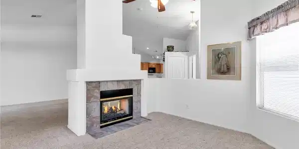 Image 4: Unfurnished living room with a ceiling fan, a fire