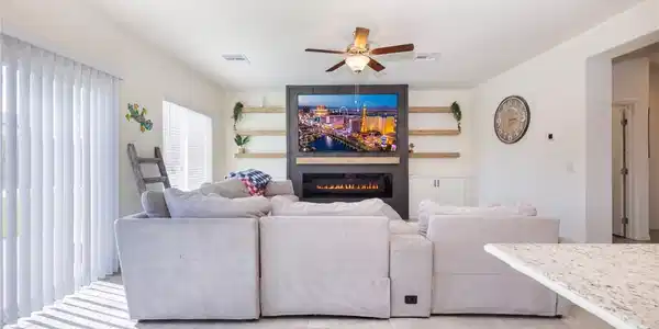 Image 2: A modern fireplace serves as the centerpiece of th