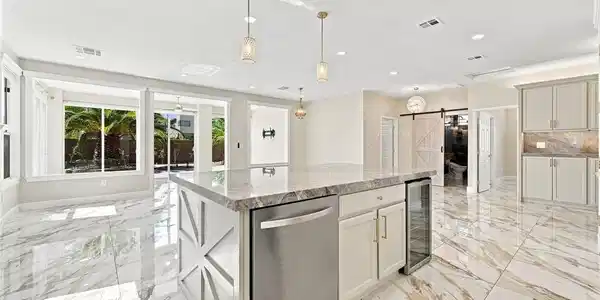 Image 2: Polished marble tile floors reflect light througho