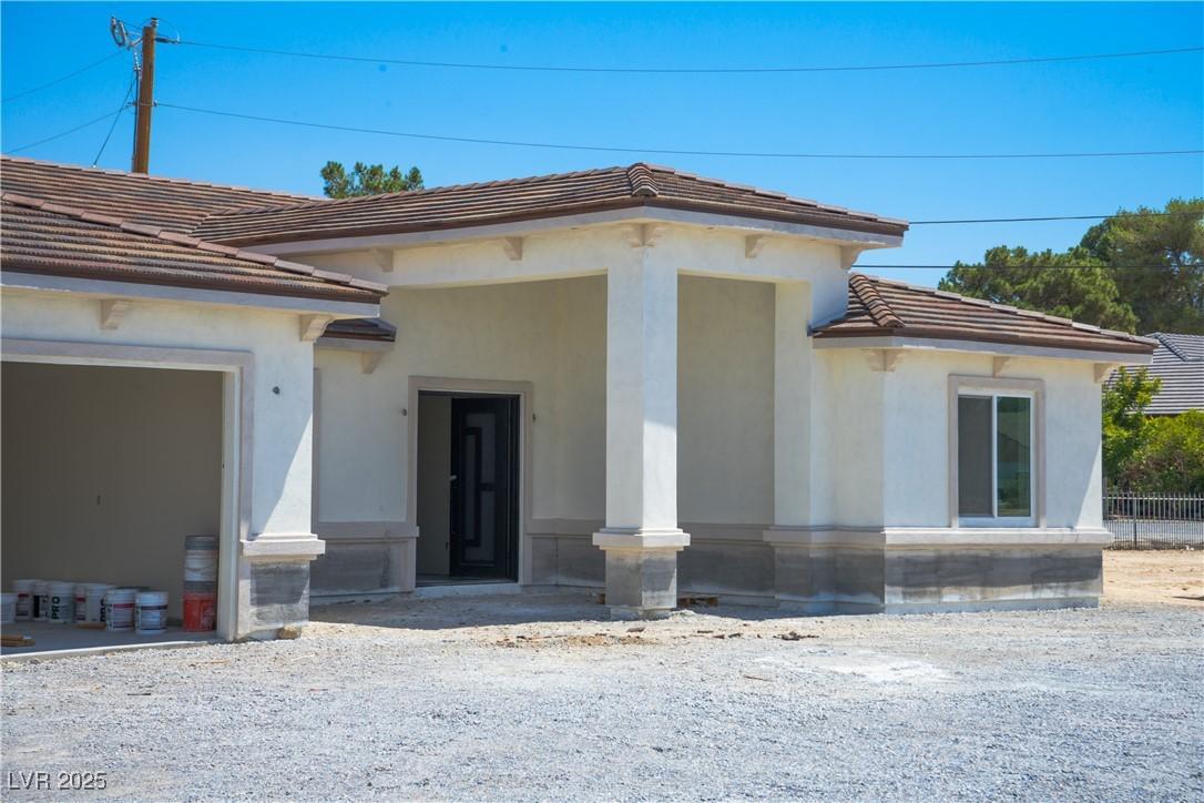 Image 3: Entrance to property featuring a tiled roof and st