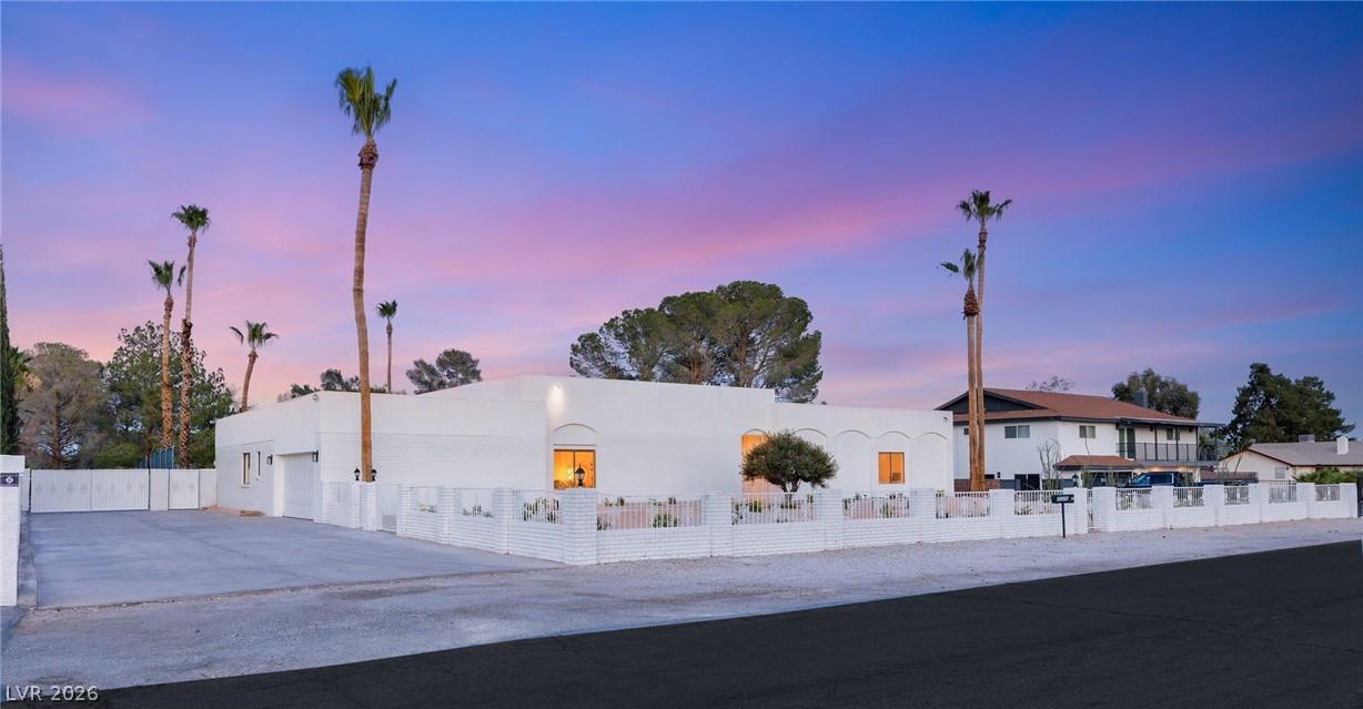 Image 2: A striking white stucco residence, accentuated by