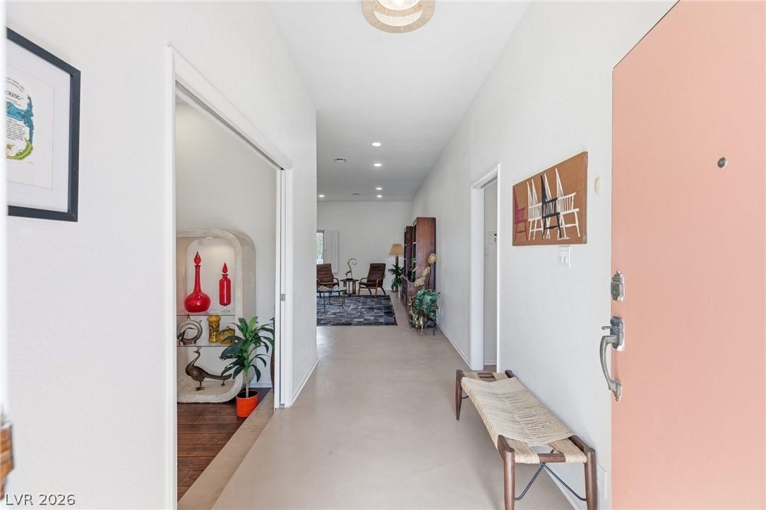 Image 4: A well-lit entry hall with recessed lighting opens