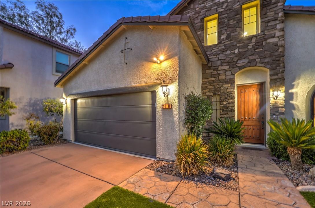 Image 4: A welcoming stone-clad entrance and garage beckon