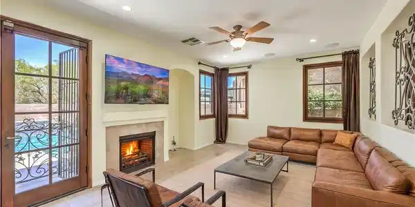 Image 4: A cozy gathering room features a warm fireplace an