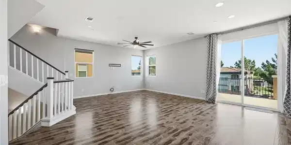 Image 3: Hardwood floors and a wide sliding door offer natu