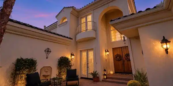 Image 2: Warm exterior lighting accentuates the elegant ent