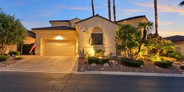 Image 3: Lush desert landscaping accents this Mediterranean
