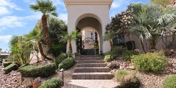 Image 4: An arched entry portico and stone steps lead towar