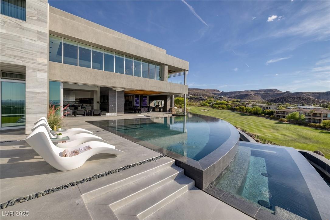 Image 3: View of swimming pool featuring a mountain view an