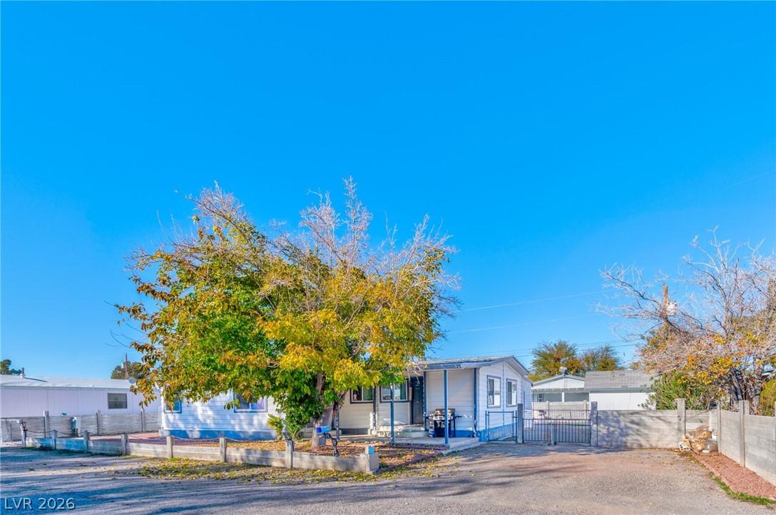Image 2: View of front of property with a fenced front yard