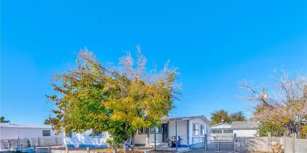 Image 2: View of front of property with a fenced front yard