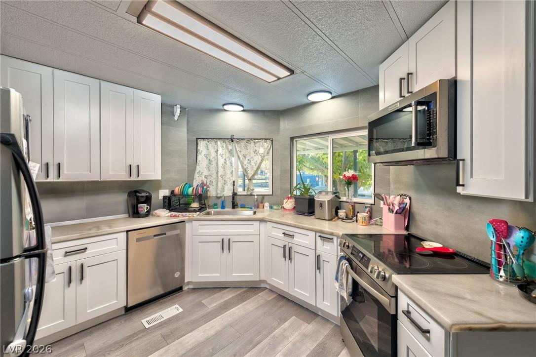 Image 4: Kitchen featuring stainless steel appliances, whit