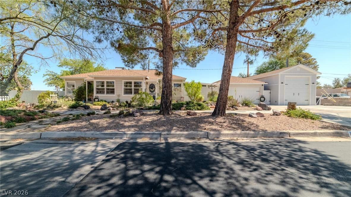 Image 2: A welcoming front yard with mature trees shades a