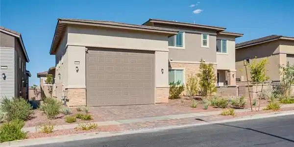 Image 2: A contemporary residence with a paneled garage doo