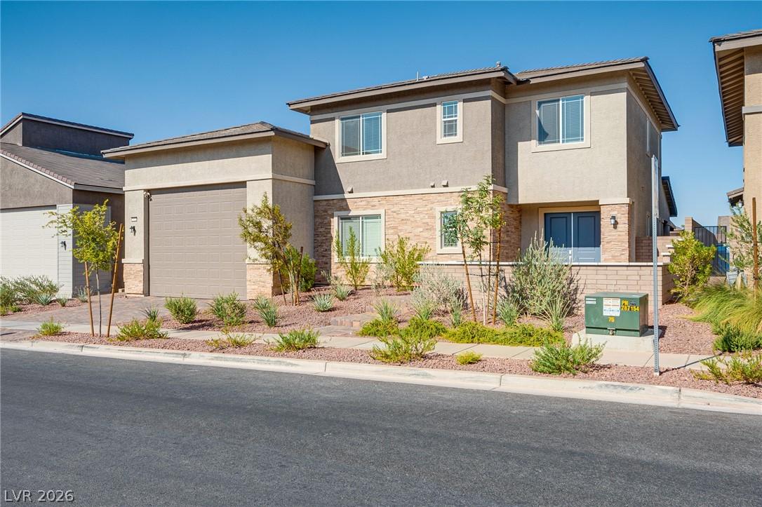 Image 3: A contemporary desert home features an attached ga