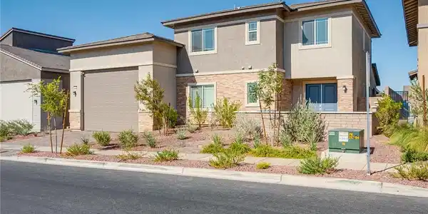 Image 3: A contemporary desert home features an attached ga