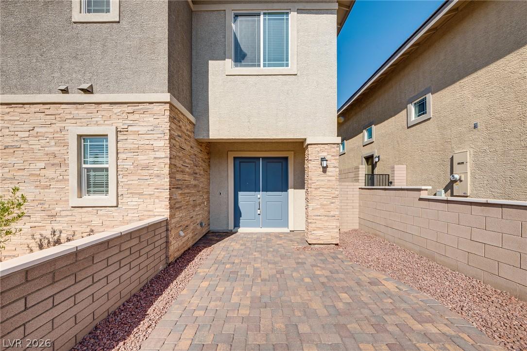 Image 4: A welcoming paver driveway leads to the attractive