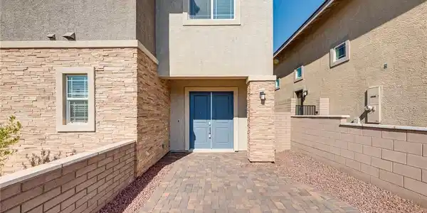 Image 4: A welcoming paver driveway leads to the attractive