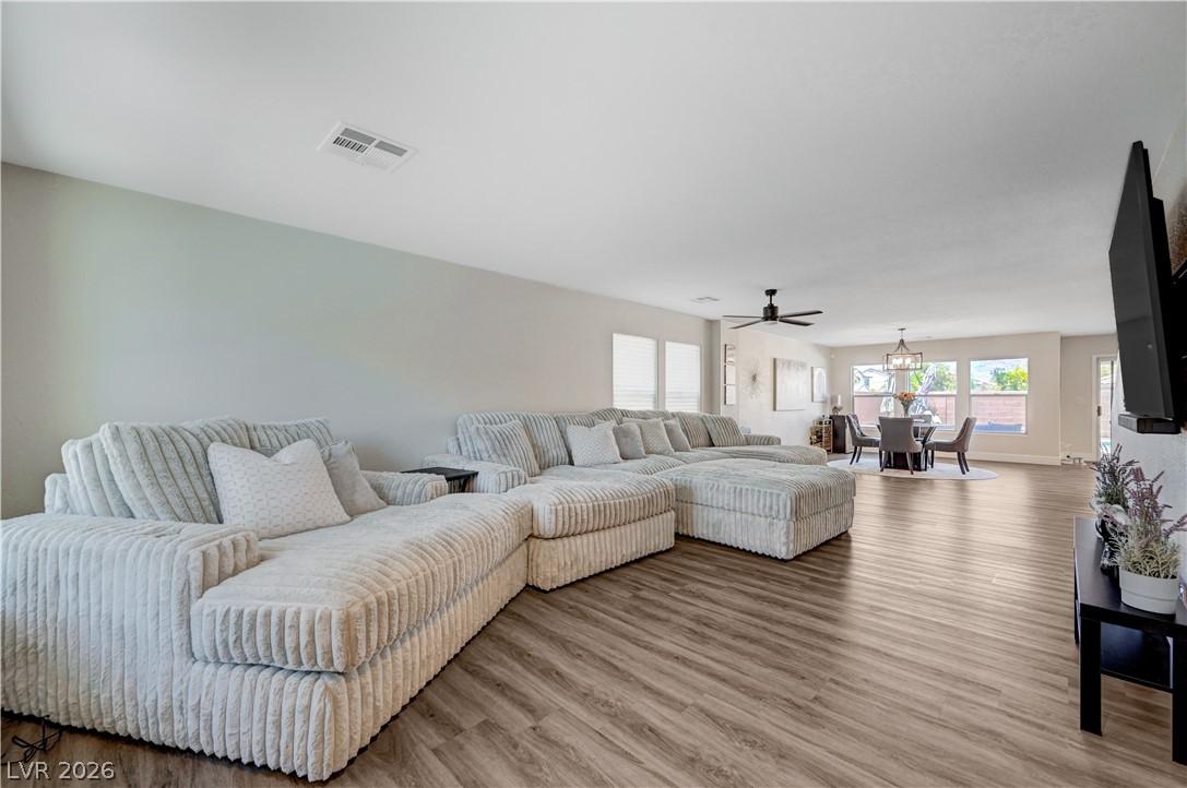 Image 3: An open concept living area boasts a spacious layo