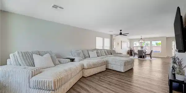 Image 3: An open concept living area boasts a spacious layo