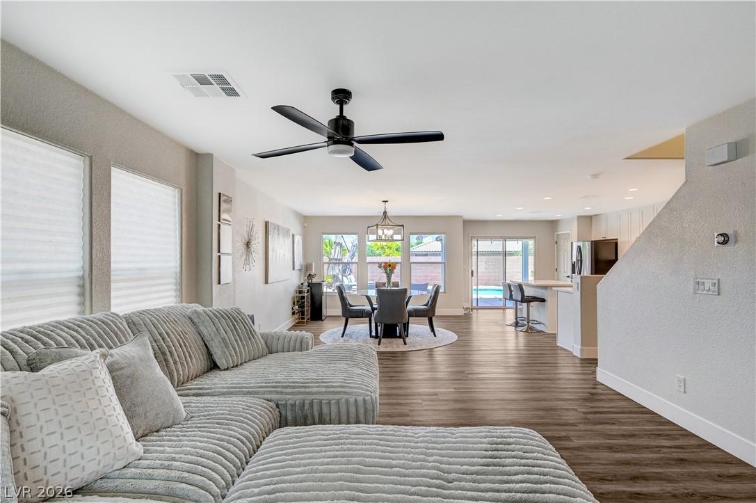 Image 4: An open-concept interior featuring rich wood floor