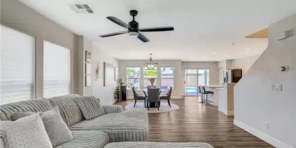 Image 4: An open-concept interior featuring rich wood floor