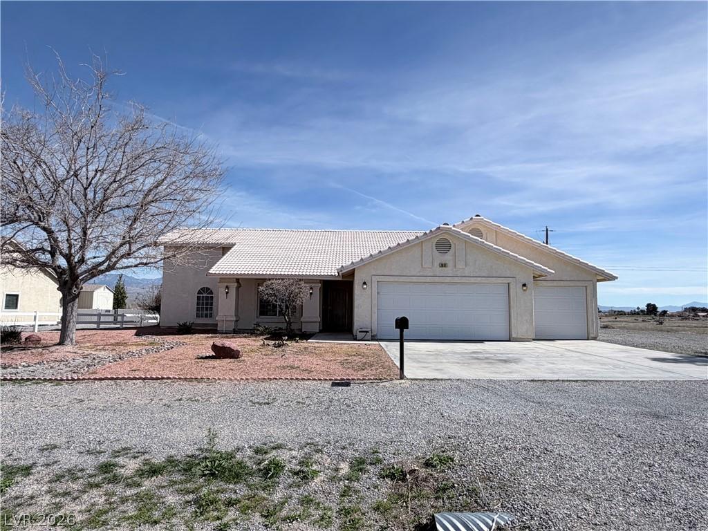 Image 1: Ranch-style home with concrete driveway, an attach