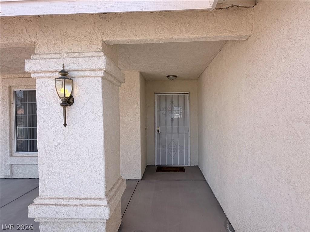 Image 4: Doorway to property featuring stucco siding
