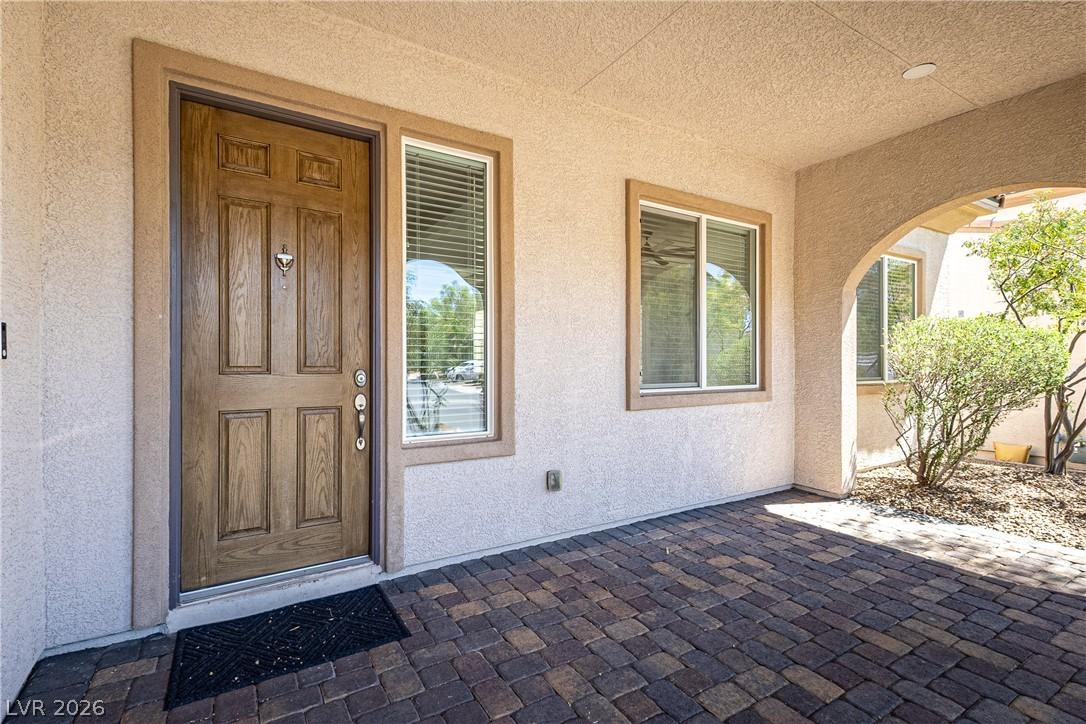 Image 2: A welcoming front entry features an arched covered