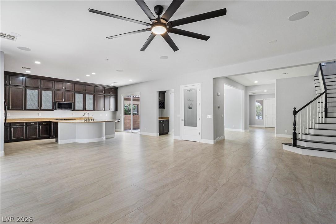 Image 4: An open-concept living area with a central kitchen