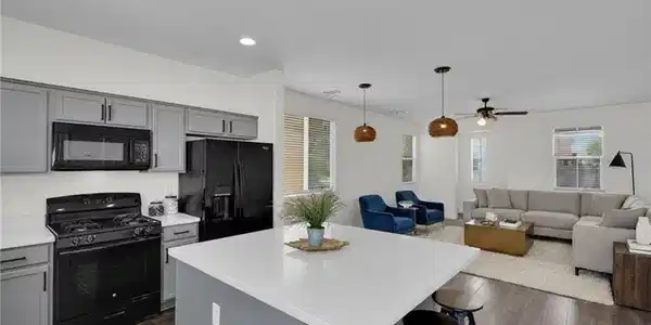 Image 4: An open-concept living space integrates a well-app