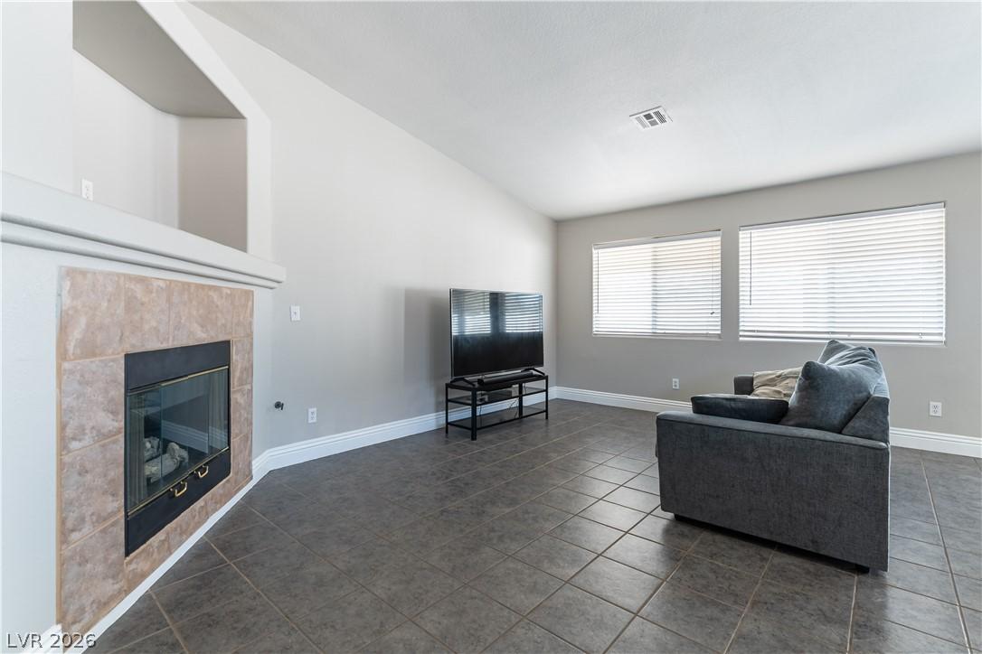 Image 4: A corner fireplace with a tiled surround anchors t