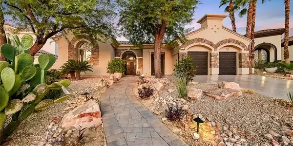 Image 2: A stone-paved walkway winds through low-maintenanc