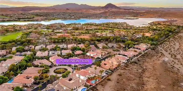Image 4: A striking neighborhood borders a vast blue lake f
