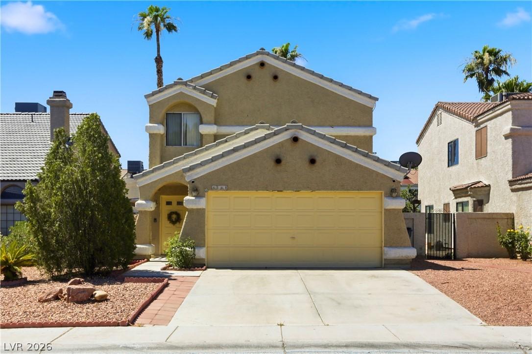 Image 1: A classic facade with a paved driveway and low-mai