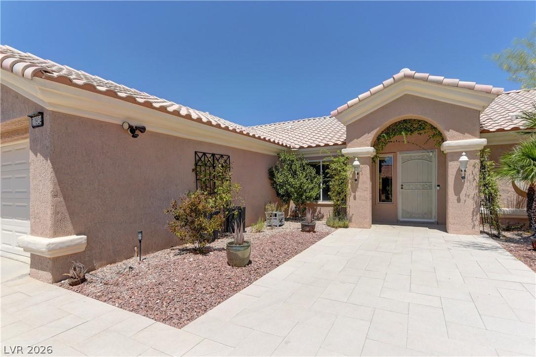 Image 3: This home features a welcoming arched entryway, se