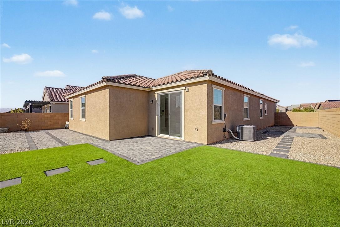 Image 3: A well-maintained backyard with a mix of artificia