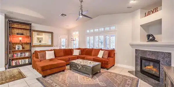 Image 2: Tiled flooring and a modern fireplace elevate this