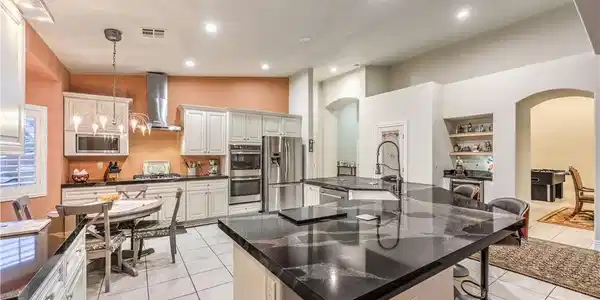 Image 4: Gleaming granite countertops and a spacious centra