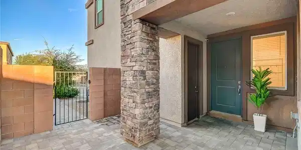Image 3: A stone pillar accents the covered front entryway