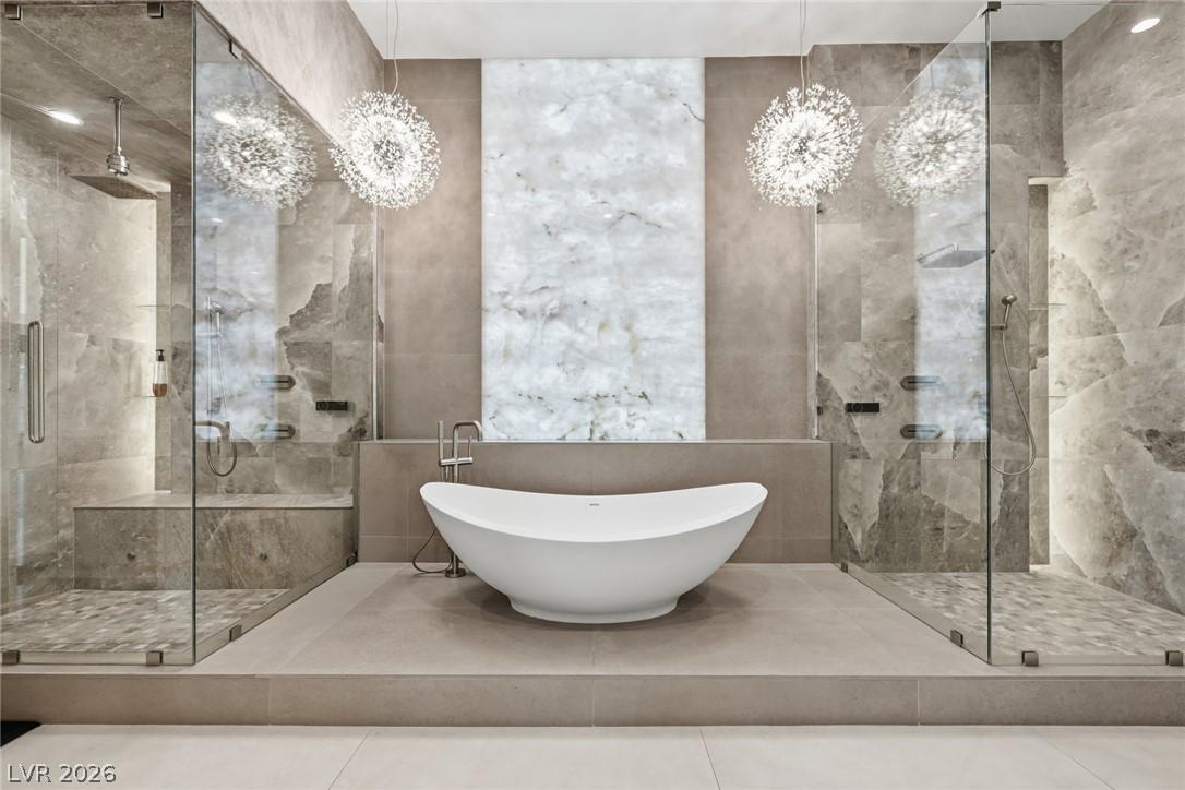 Image 3: Spa-inspired primary bath featuring dual walk-in s
