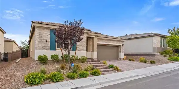 Image 4: Stone accents and manicured desert landscaping cre