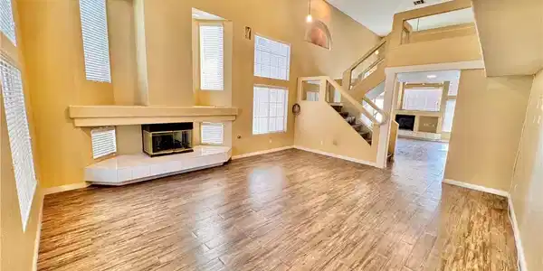 Image 2: Dramatic vaulted ceilings and a classic fireplace
