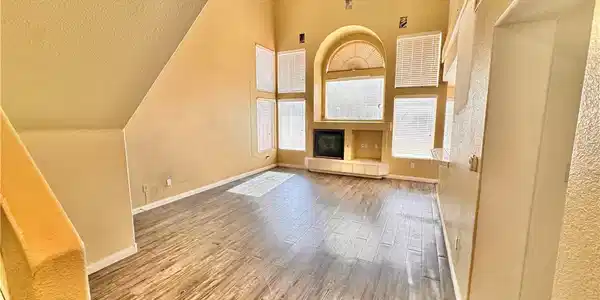 Image 3: Sleek wood-look flooring anchors this airy living