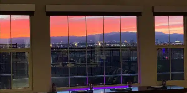 Image 2: Large picture windows frame incredible city lights