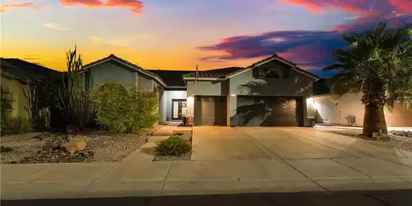 Image 2: Desert landscaping and a spacious concrete drivewa