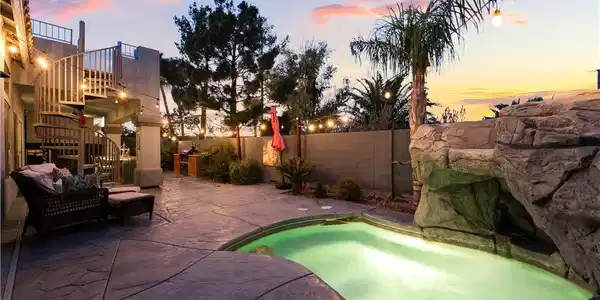 Image 3: Stamped concrete surrounds an inviting pool featur