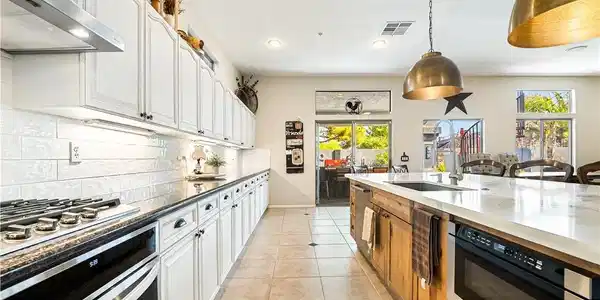 Image 4: Tiled floors and a sprawling kitchen island ground
