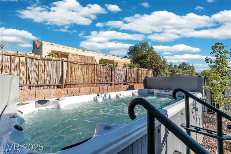 Image 2: View of pool featuring a hot tub